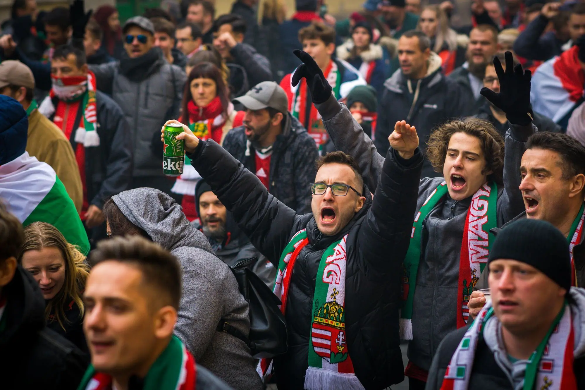 Football fans in scarves cheering together